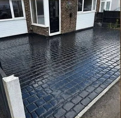 Pattern imprinted concrete driveway with a fresh sealant coat