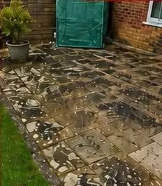 Sandstone patio covered in black spot before cleaning